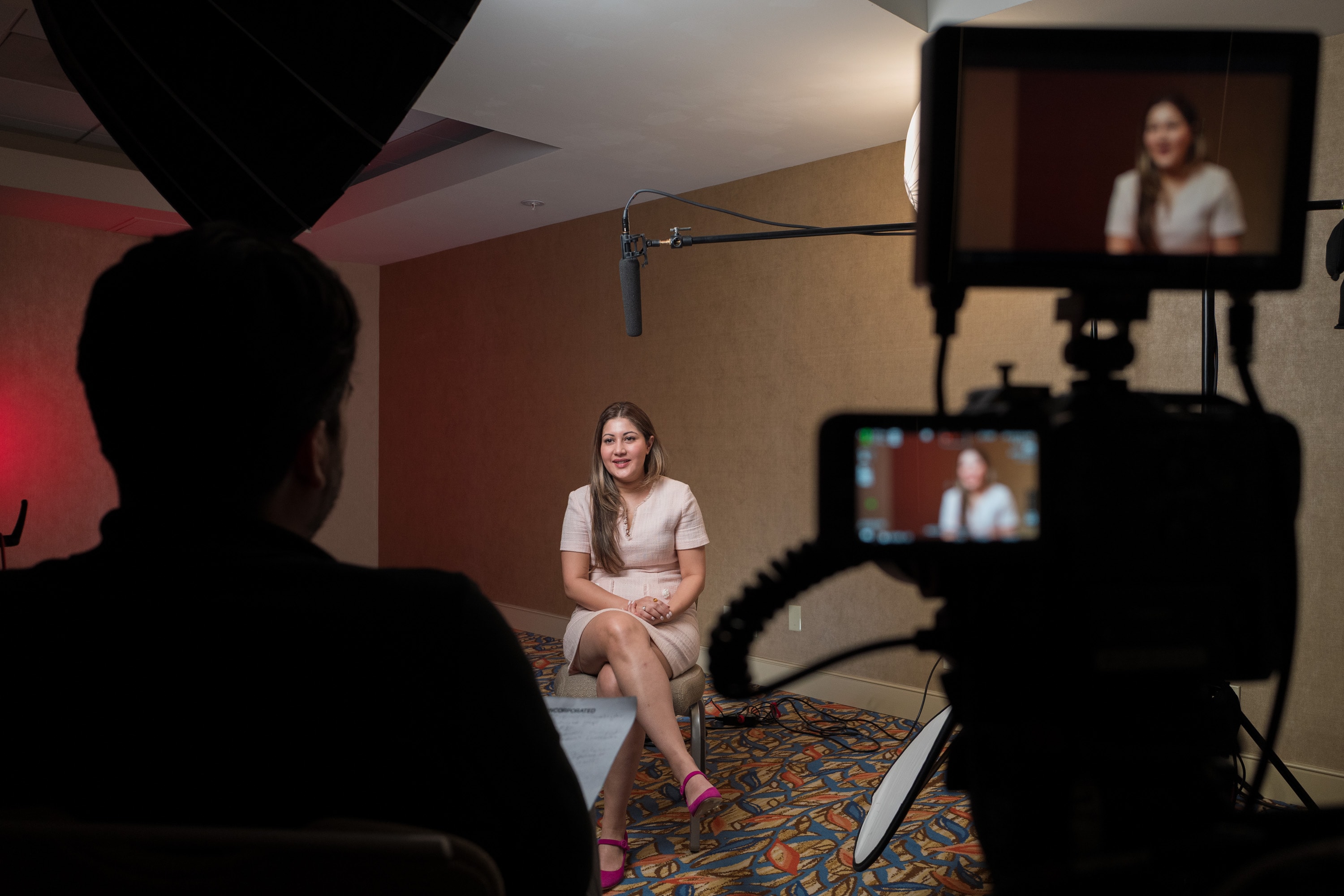 Carlos Foster directing a brand film interview, soft natural lighting on the subject