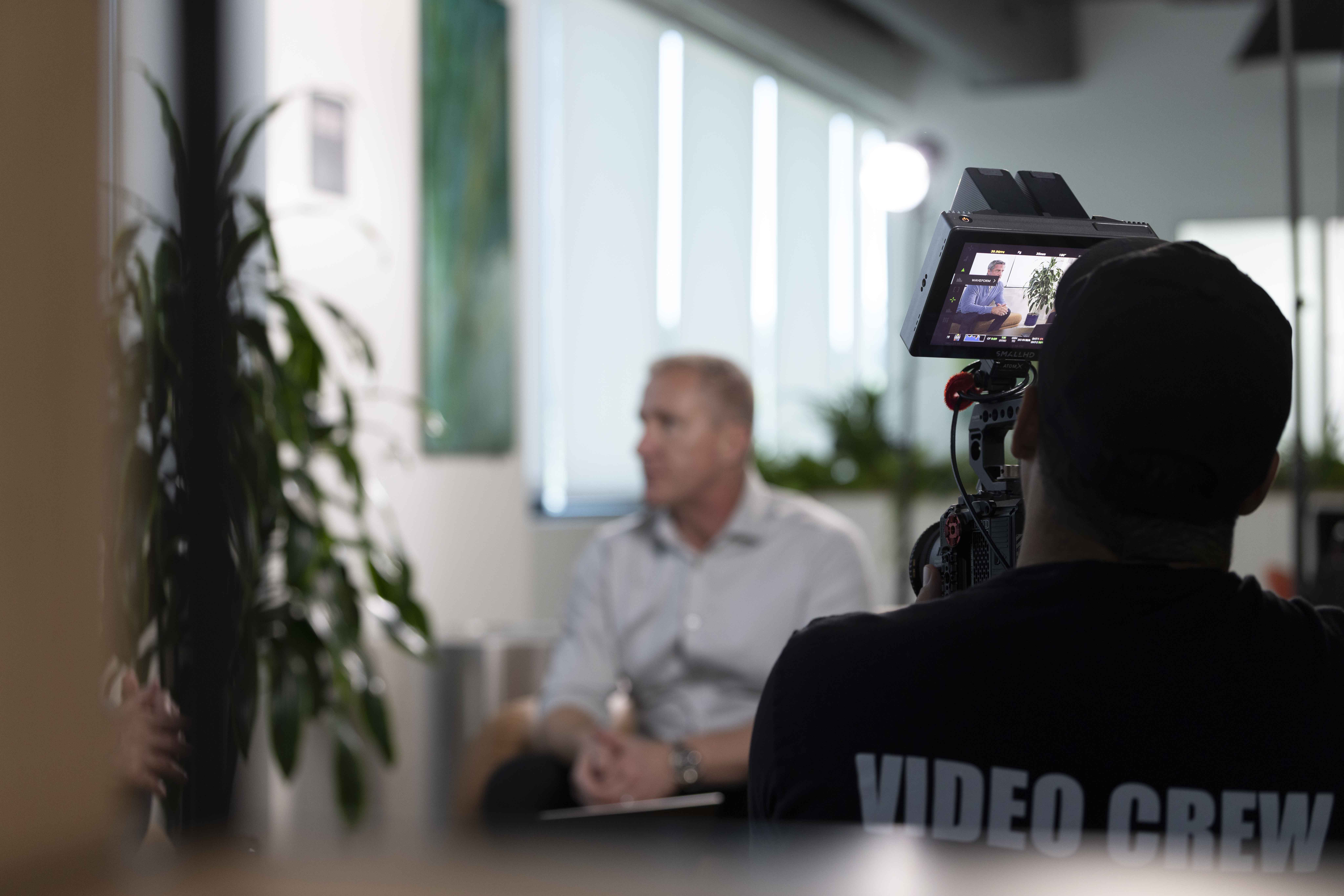 Blue Barn videographer filming a corporate interview subject