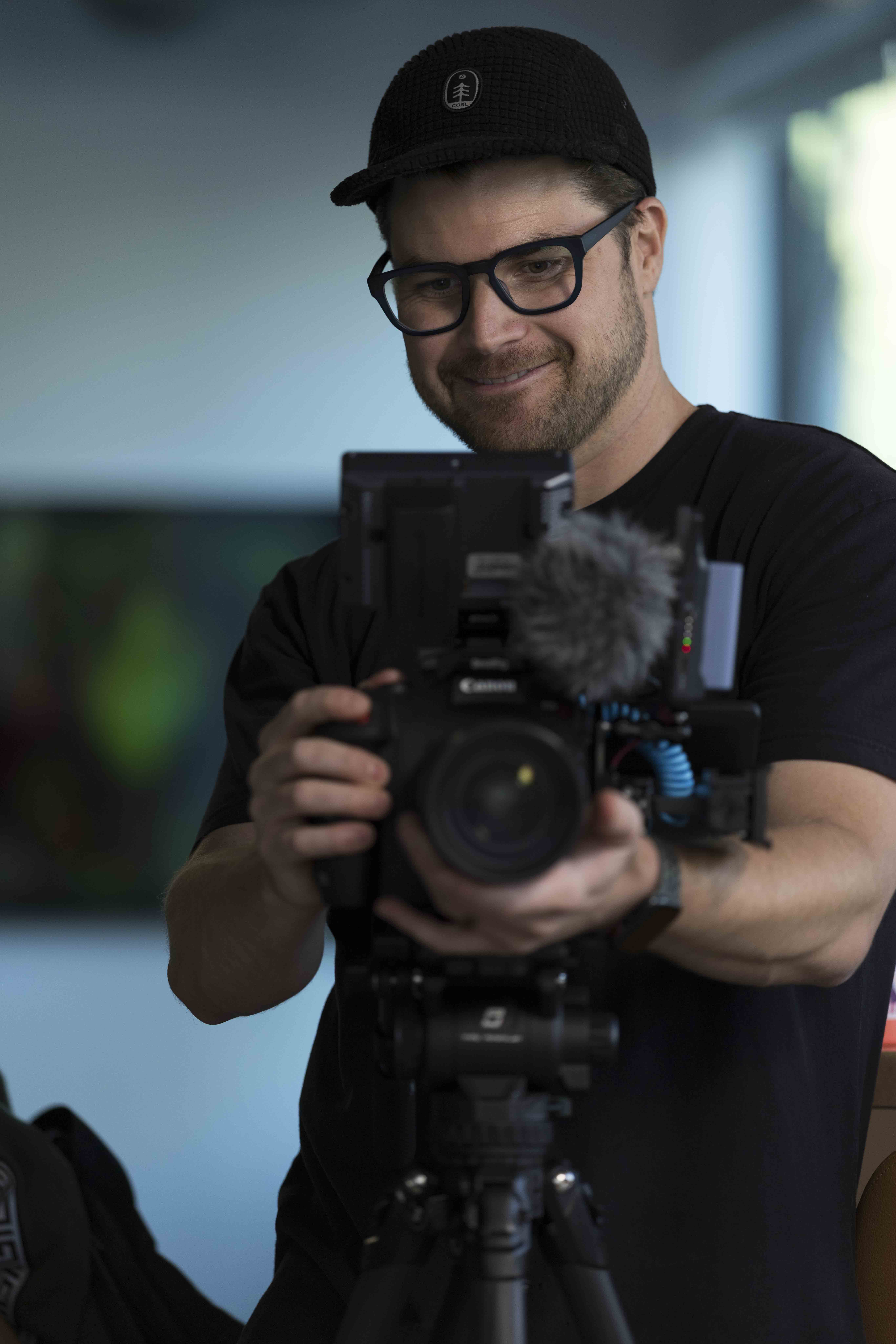 Max, Blue Barn videographer, filming on set
