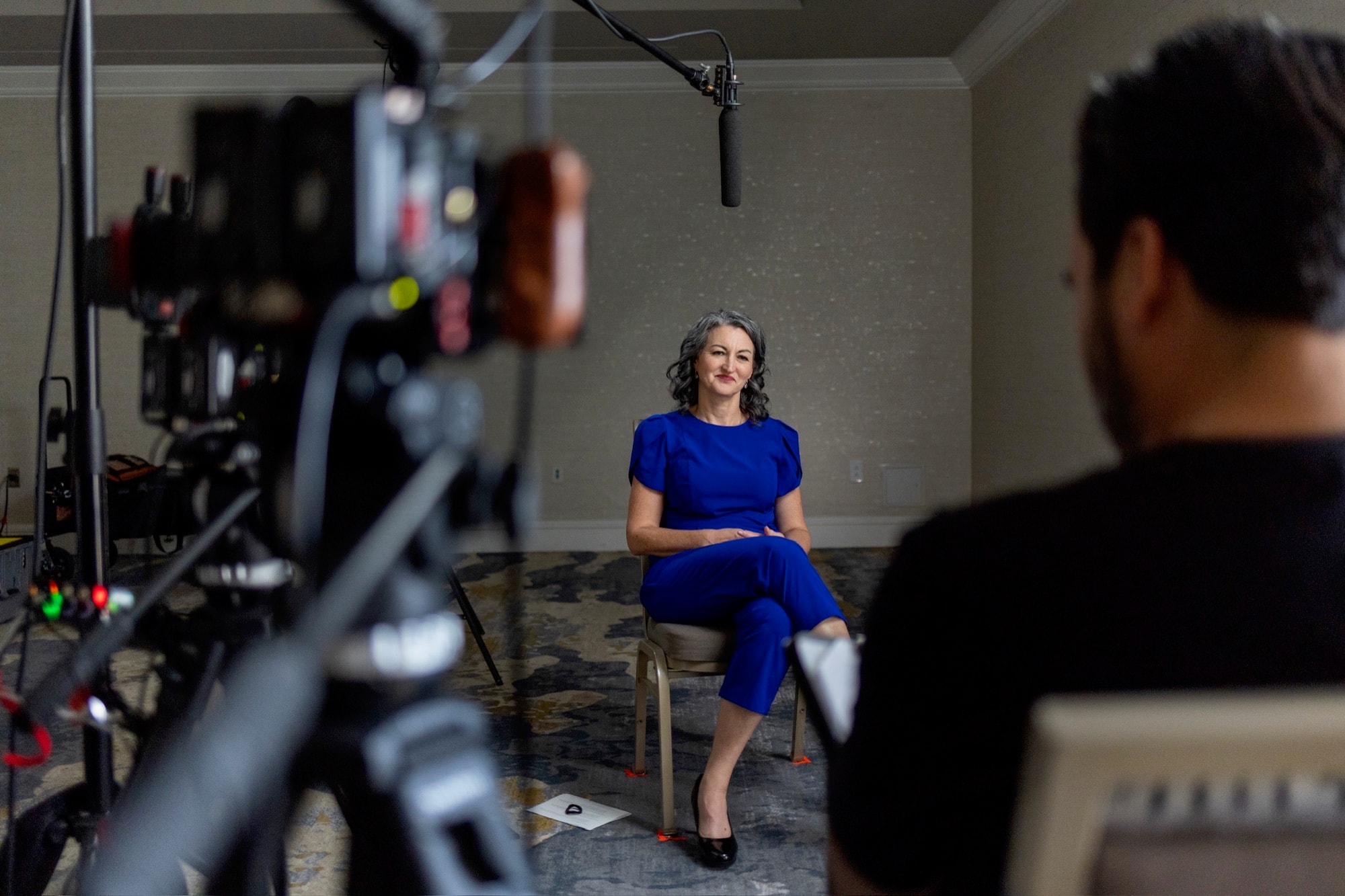 Carlos Foster interviewing a woman at a business conference for a customer story