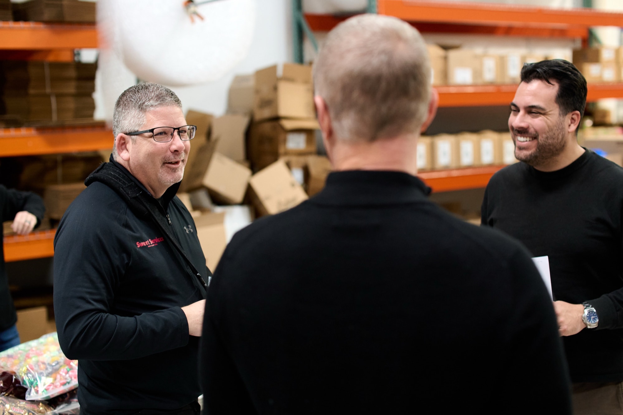 Carlos Foster speaking with clients on a customer story production day