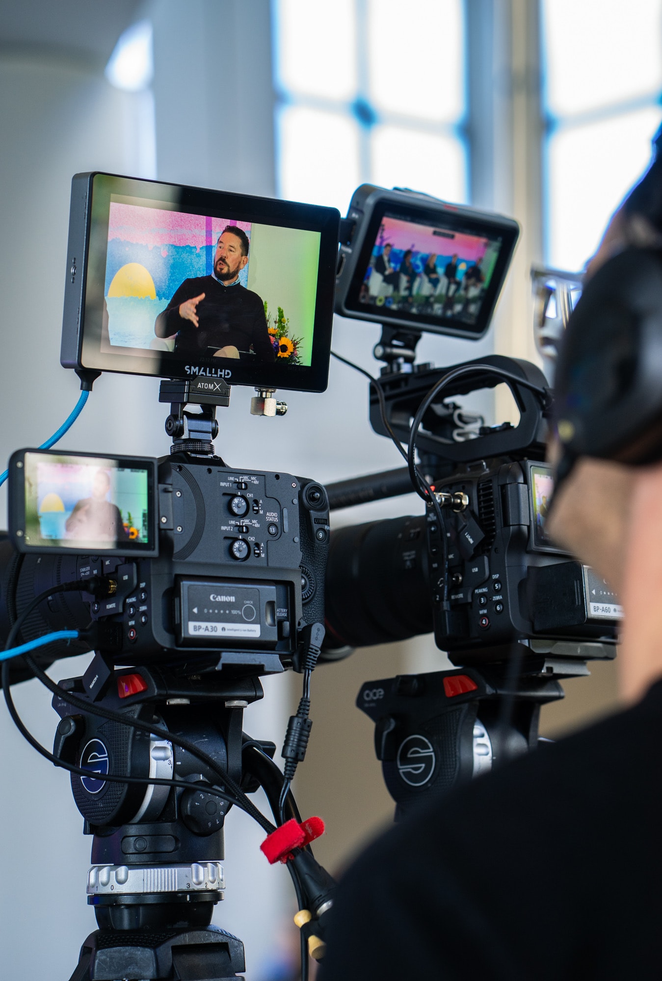 Blue Barn videographer with on-camera monitor at a small stage event