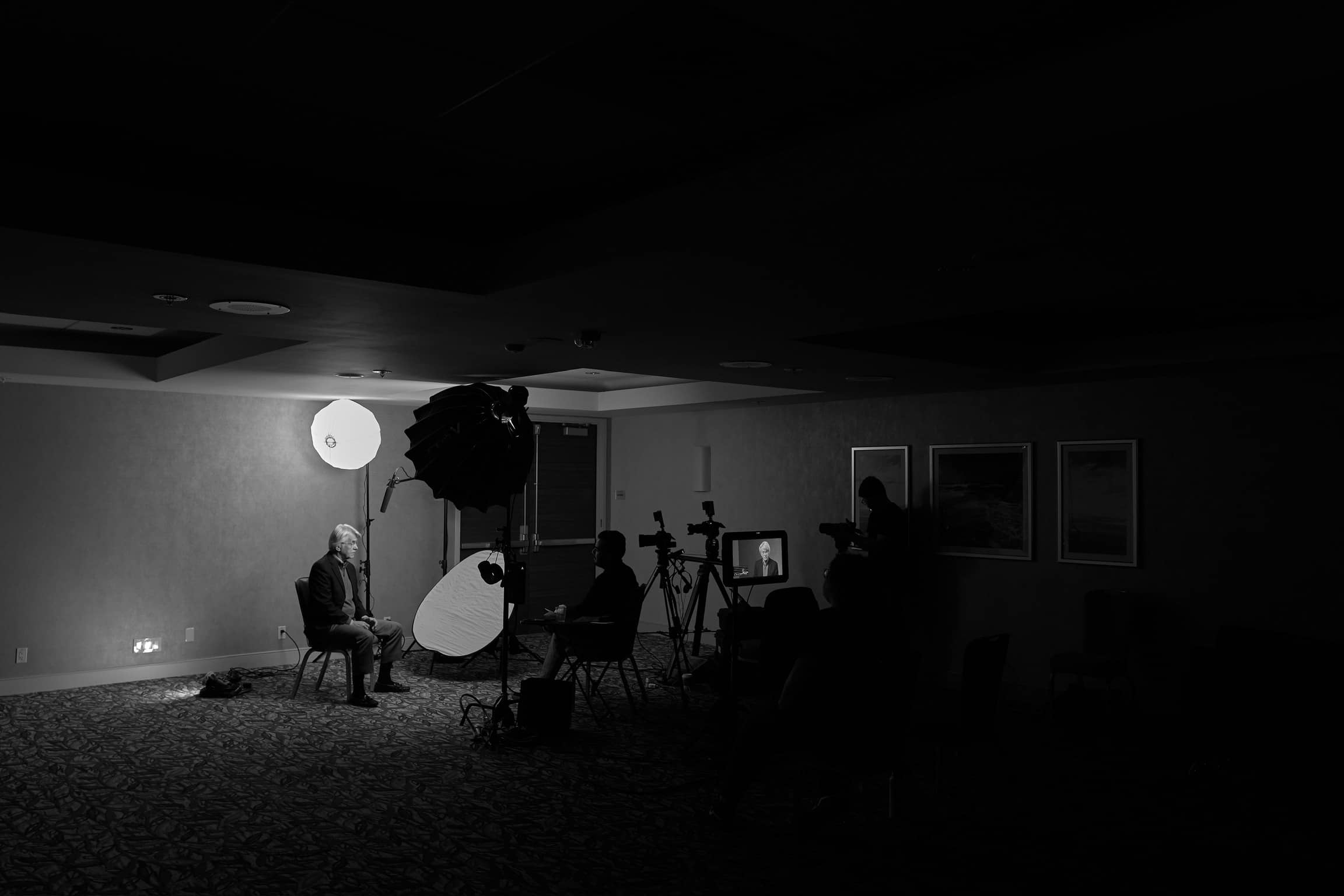 Cinematic black-and-white interview setup at a corporate conference