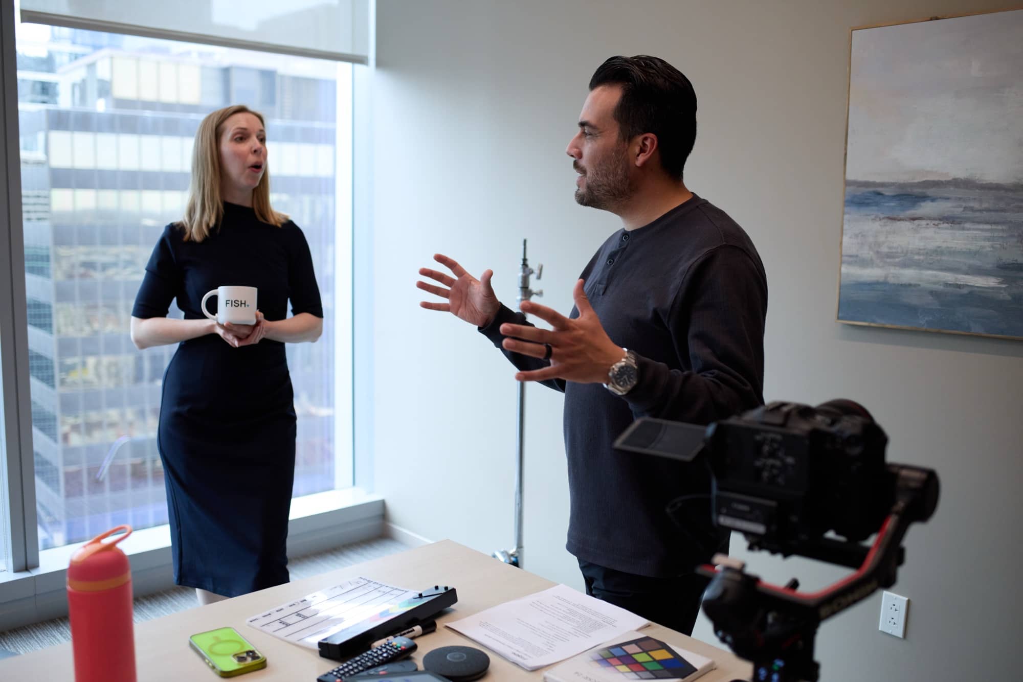 Carlos Foster consulting with a client on set