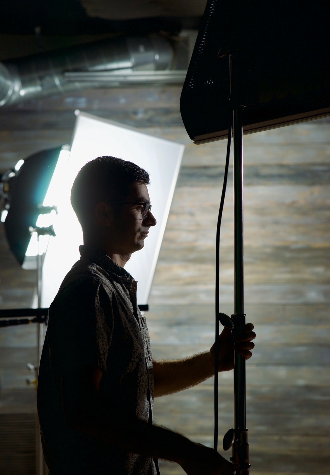 Blue Barn Creative crew member adjusting studio lighting on set