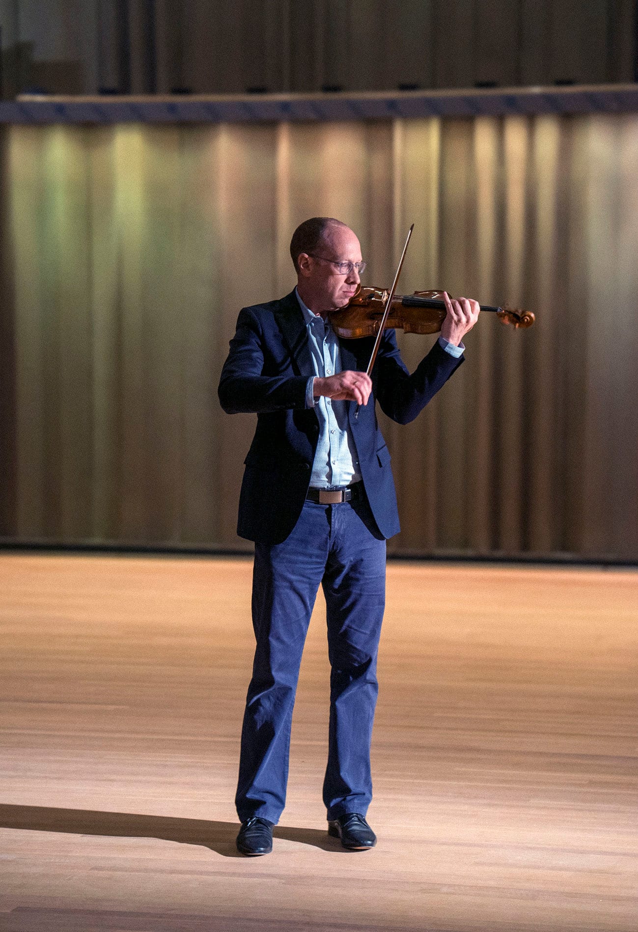 A San Diego Symphony violinist performing on stage at the newly renovated Jacobs Music Center
