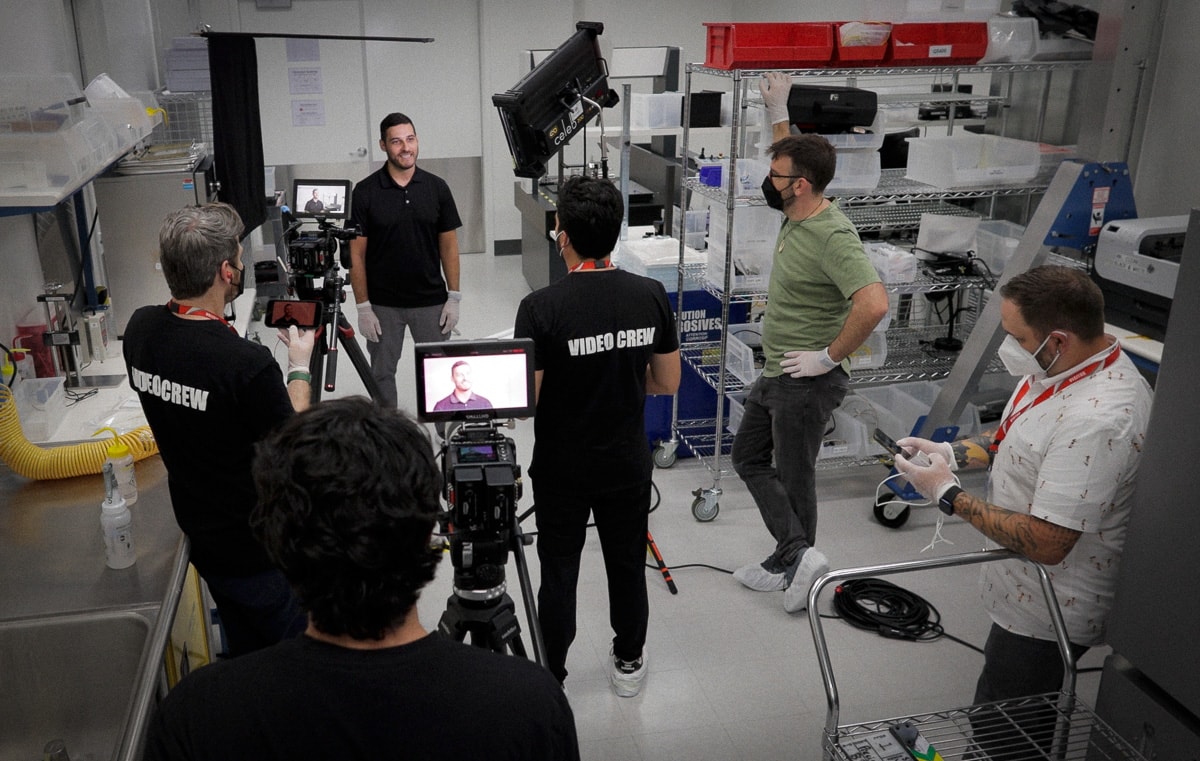 Stephen Alberts, Carlos Foster, and Enrique filming inside the Quartus Engineering clean room