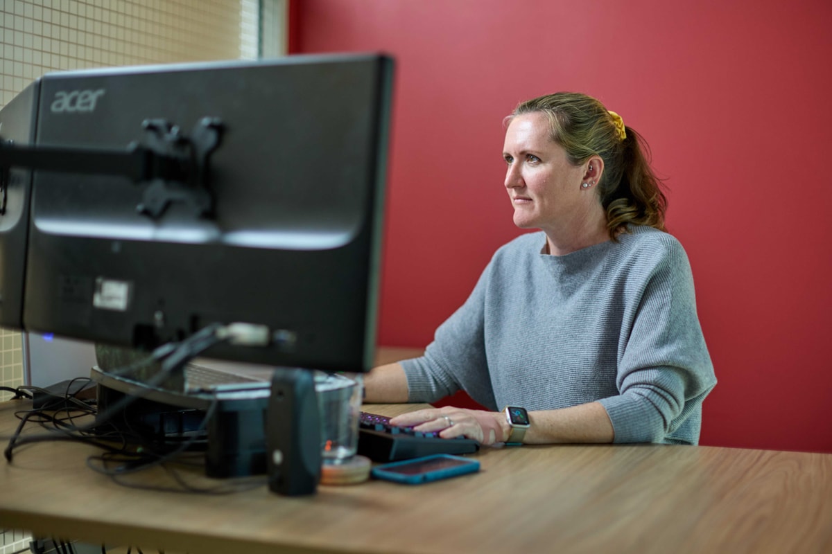 Business photography of a Quartus Engineering employee working in her office